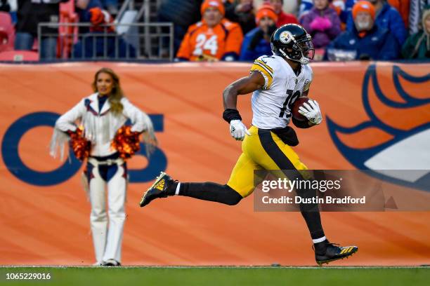 Wide receiver JuJu Smith-Schuster of the Pittsburgh Steelers runs after a catch and scores on a 97 yard catch and run in the third quarter of a game...