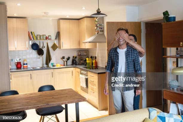 man surprising his partner arriving home - hands covering eyes stock pictures, royalty-free photos & images