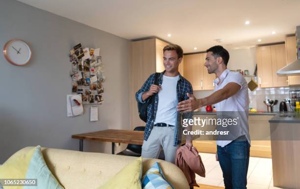 man showing his home to his new flat mate - student flat stock pictures, royalty-free photos & images