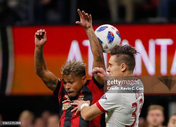 Josef Martinez of Atlanta United competes for a header against Aaron Long of New York Red Bulls during the MLS Eastern Conference Finals between...