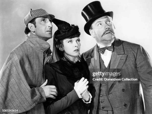 Actress Ida Lupino, Basil Rathbone and Nigel Bruce in a scene from the movie "The Adventures of Sherlock Holmes"