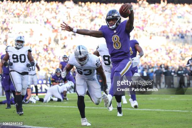 Quarterback Lamar Jackson of the Baltimore Ravens rushes for a touchdown during the third quarter against the Oakland Raiders at M&T Bank Stadium on...