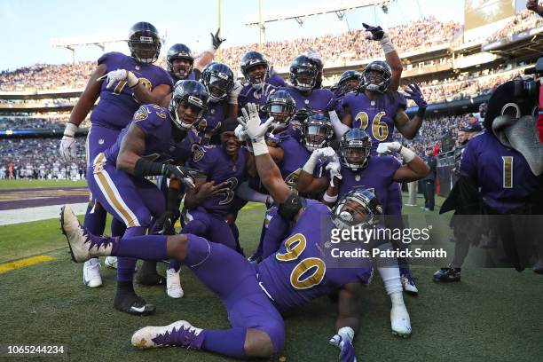 Outside linebacker Terrell Suggs of the Baltimore Ravens celebrates his touchdown after a fumble recovery against the Oakland Raiders with teammates...