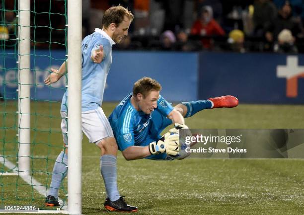 Tim Melia of Sporting Kansas City makes a save on a shot as Seth Sinovic backs him up during the second half of the match against the Portland...