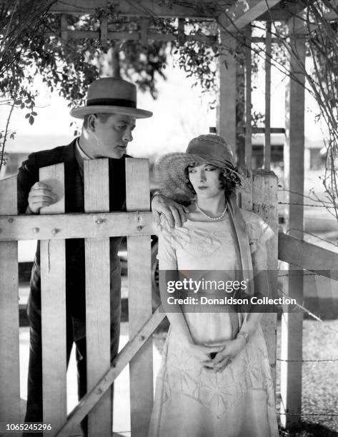 Actress Marian Nixon,Reginald Denny in a scene from the movie "Rolling Home"