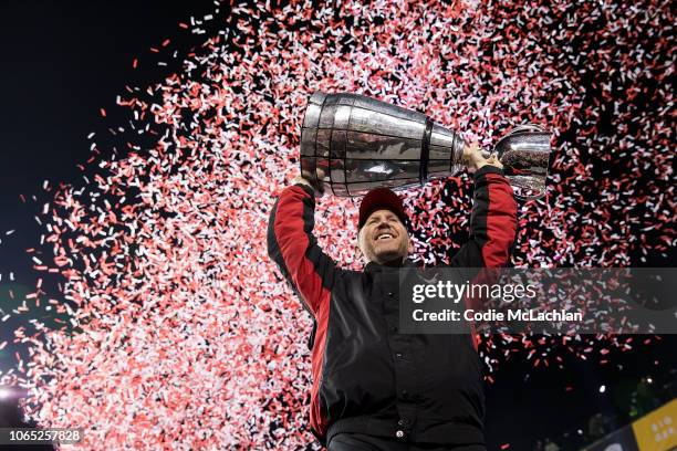 Head coach Dave Dickenson of the Calgary Stampeders hoists the Grey Cup after defeating the Ottawa Redblacks during the second half of the Grey Cup...