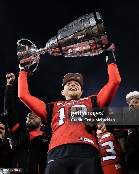 Quarterback Bo Levi Mitchell of the Calgary Stampeders hoists the Grey Cup after defeating the Ottawa Redblacks during the second half of the Grey...