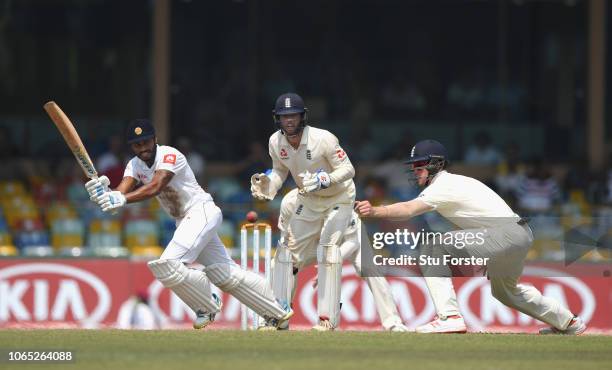 Sri Lanka batsman Roshen Silva picks up some runs past Keaton Jennings as Ben Foakes looks on during Day Four of the Third Test match between Sri...