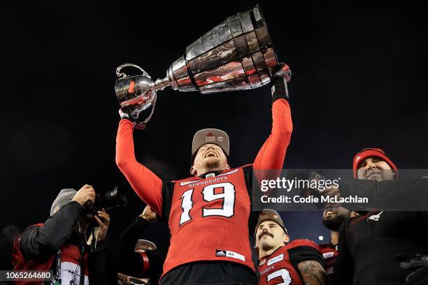 Quarterback Bo Levi Mitchell of the Calgary Stampeders hoists the Grey Cup after their victory against the Ottawa Redblacks during the Grey Cup game...