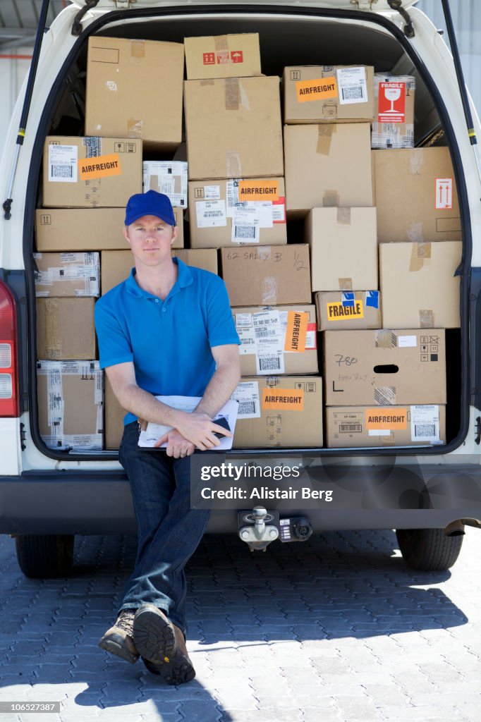 Delivery Rider Behind Lorry Delivery Man Sitting At Back Of Van High-Res Stock Photo - Getty Images