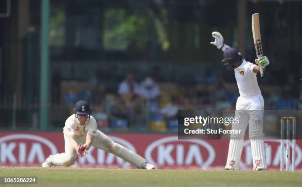 Sri Lanka batsman Niroshan Dickwella reacts as short leg fielder Keaton Jennings takes the catch during Day Four of the Third Test match between Sri...