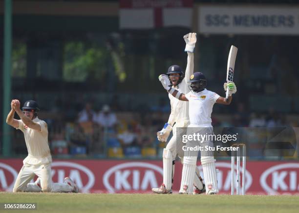 Sri Lanka batsman Niroshan Dickwella reacts as short leg fielder Keaton Jennings takes the catch during Day Four of the Third Test match between Sri...