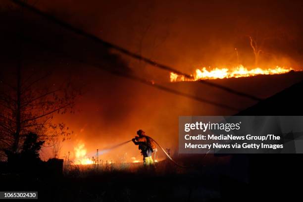 Firefighters battle the Camp Fire on Silvera Court in Paradise, Calif., late Thursday, November 8, 2018.