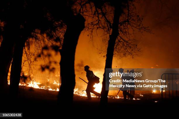 Firefighters battle the Camp Fire on Silvera Court in Paradise, Calif., late Thursday, November 8, 2018.