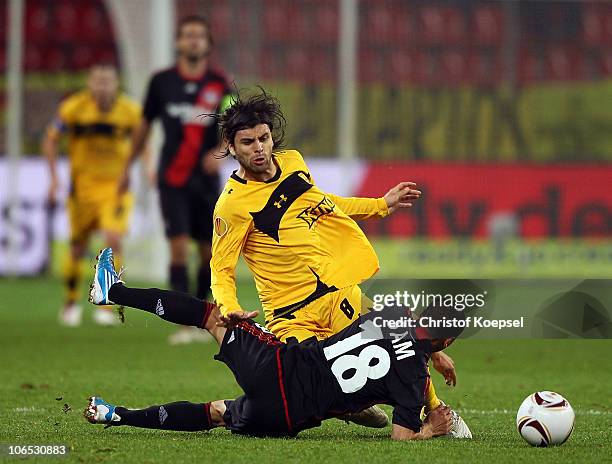 Sidney Sam of Leverkusen challenges Juan Carlos Toja of Aris Thessaloniki during the UEFA Europa League Group B match between Bayer Leverkusen and...