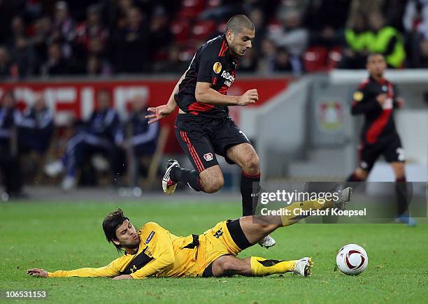 Juan Carlos Toja of Aris Thessaloniki challenges Eren Derdiyok of Leverkusen during the UEFA Europa League Group B match between Bayer Leverkusen and...