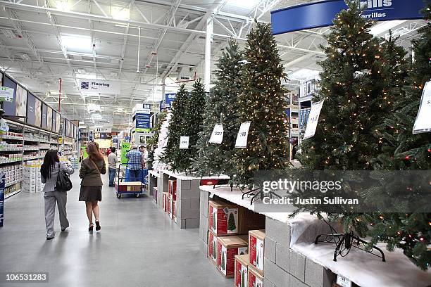 Customers at a Lowe's home improvement store walk by a display of artificial Christmas trees on November 4, 2010 in San Francisco, California. With...