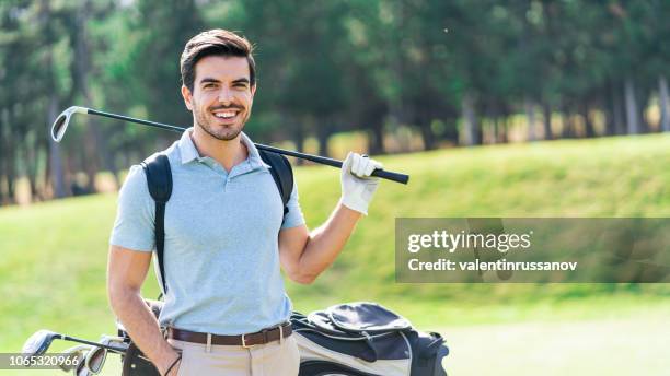 male golfer standing on golf course - golf club stock pictures, royalty-free photos & images