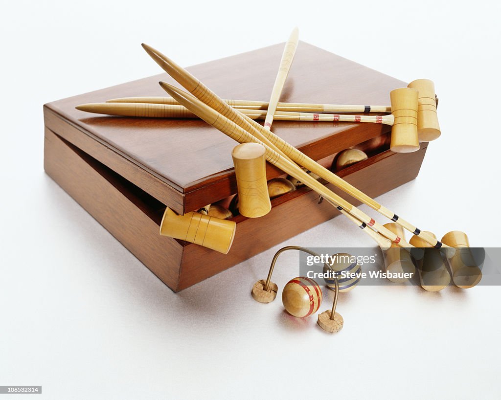 A used vintage croquet set in wood case