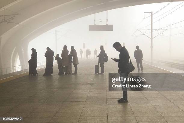 Passengers waiting at the platform in the fog on November 26, 2018 in Changzhou, Jiangsu Province, China.