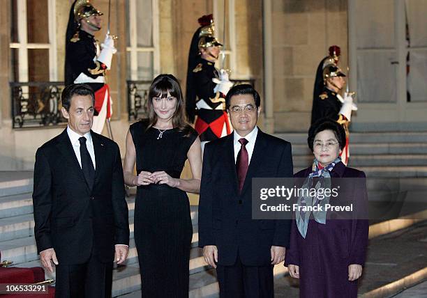 French President Nicolas Sarkozy and French First Lady Carla Bruni- Sarkozy pose with Chinese President Hu Jintao and his wife Liu Yongqing attending...