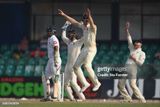 England players left to right short leg fielder Keaton Jennings, Ben Foakes and Ben Stokes appeal with success for the wicket of Suranga Lakmal after...