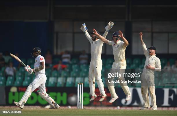 England players left to right short leg fielder Keaton Jennings, Ben Foakes and Ben Stokes appeal with success for the wicket of Suranga Lakmal after...