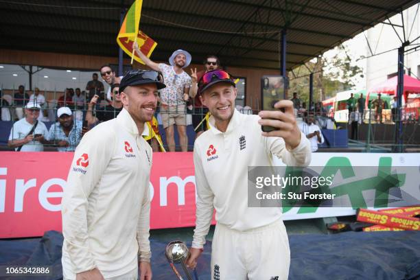 England captain Joe Root and Jack Leach pose for selfies with fans after Day Four of the Third Test match between Sri Lanka and England at Sinhalese...