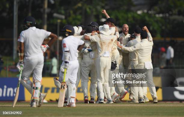 The England team celebrate the final wicket of Suranga Lakmal after a review during Day Four of the Third Test match between Sri Lanka and England at...