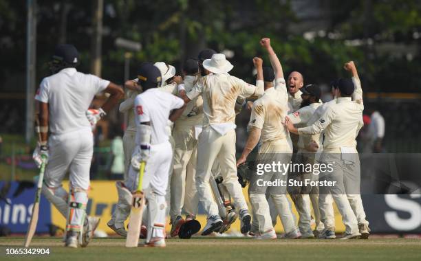 The England team celebrate the final wicket of Suranga Lakmal after a review during Day Four of the Third Test match between Sri Lanka and England at...