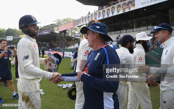 England coach Trevor Bayliss congratulates man of the series Ben Foakes during Day Four of the Third Test match between Sri Lanka and England at...