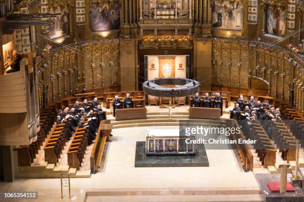 Wide -angle-view of the benedictine monk's choir is singing in the basilica of abbey Montserrat. View from the matroneum.