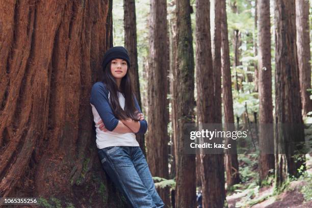 portrait of confident girl in a redwood forest - leaning tree stock pictures, royalty-free photos & images