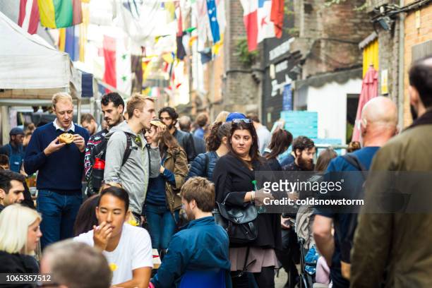 tourists and customers exploring maltby street food market, london, uk - bermondsey stock pictures, royalty-free photos & images