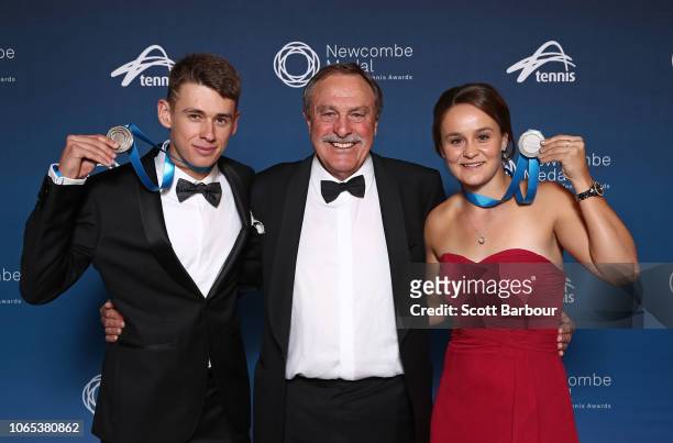 Alex de Minaur and Ashleigh Barty pose with John Newcombe and the Newcombe Medal during the Newcombe Medal at Crown Entertainment Complex on November...