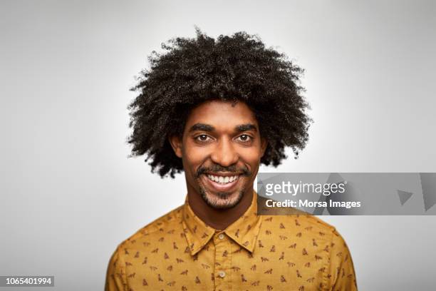 businessman smiling against white background - afro hairstyle stock-fotos und bilder