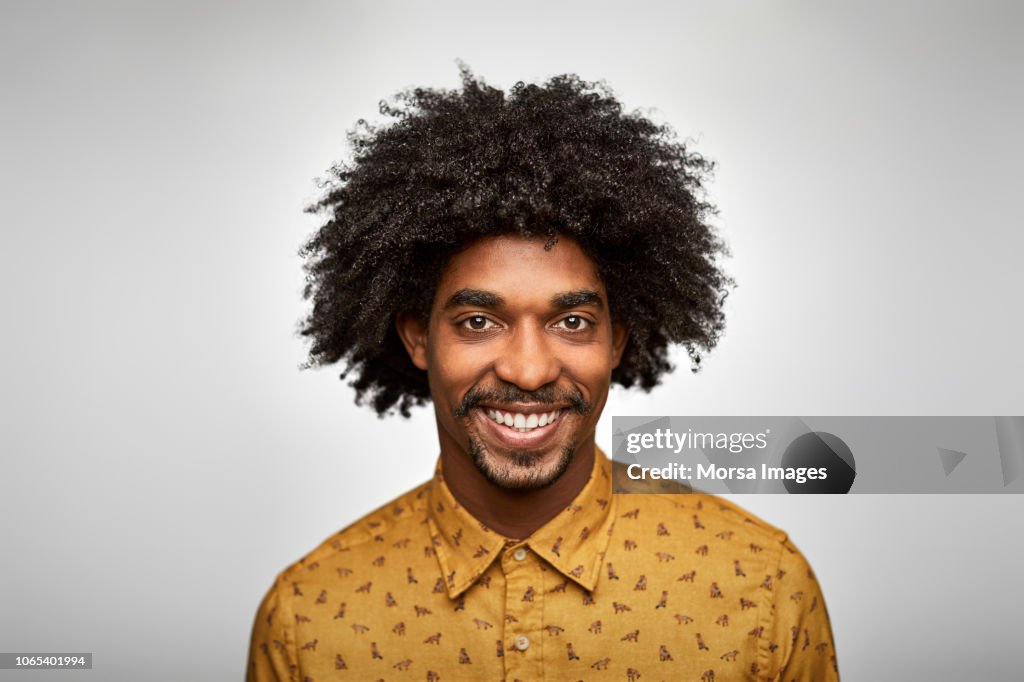 Businessman smiling against white background