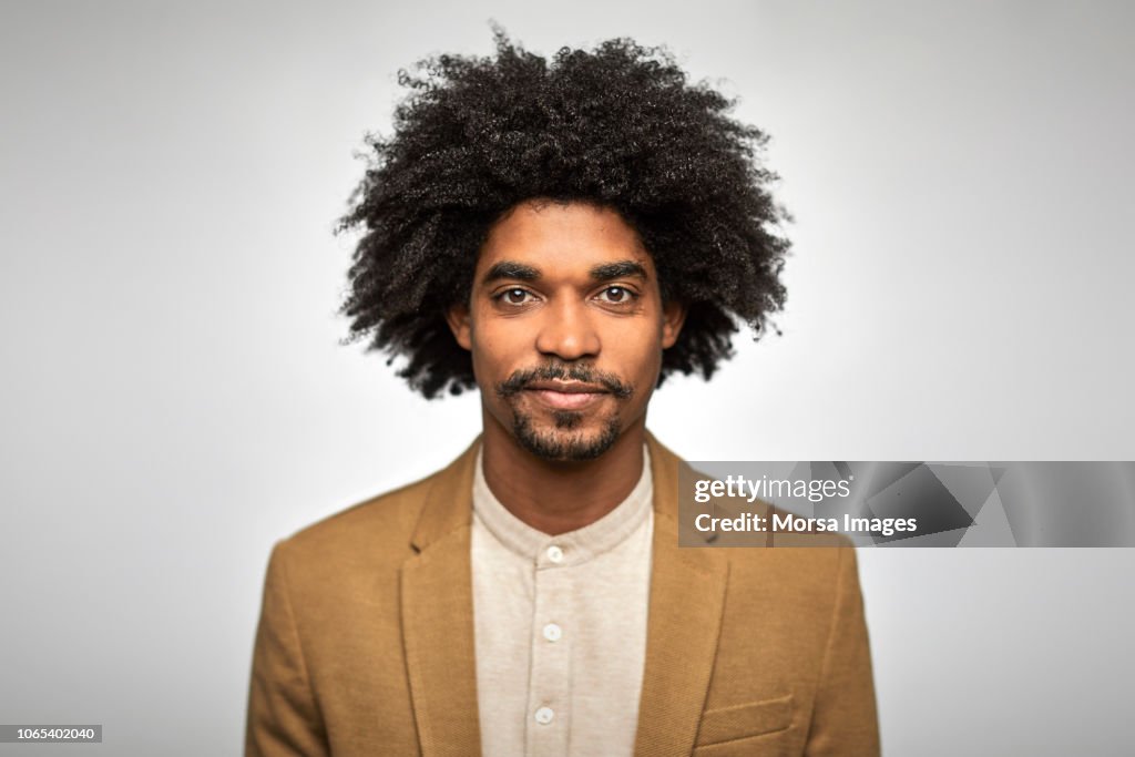 Close-up portrait of confident young businessman