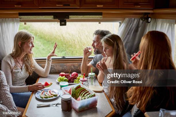 family in a caravan eating fruit - caravan holiday family imagens e fotografias de stock