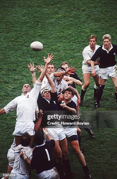 Paul Ackford of England reaches the ball ahead of Chris Gray of Scotland during the Five Nations Championship match played at Twickenham, in London....