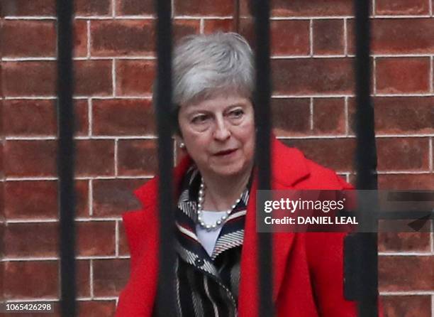 Britain's Prime Minister Theresa May leaves from the rear entrance of 10 Downing Street in London on November 26, 2018 to give a statement to the...