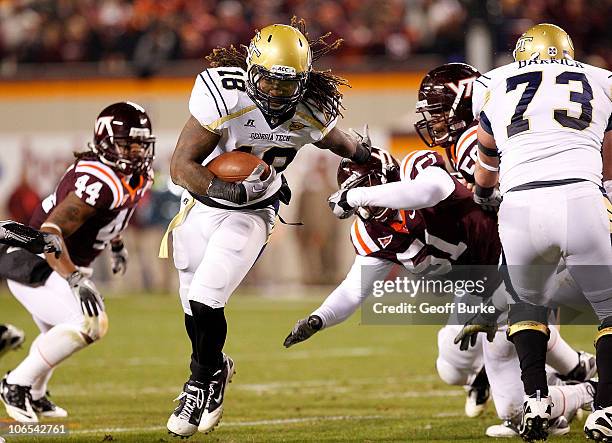 Running back Anthony Allen of the Georgia Tech Yellow Jackets runs with the ball as linebacker Bruce Taylor of the Virginia Tech Hokies chases at...