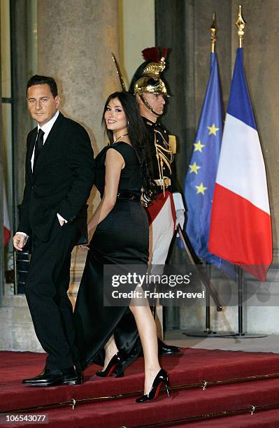 French Immigration Minister Eric Besson and his wife Yasmine Tordjman arrive to attend a state dinner honouring visiting Chinese President Hu Jintao...