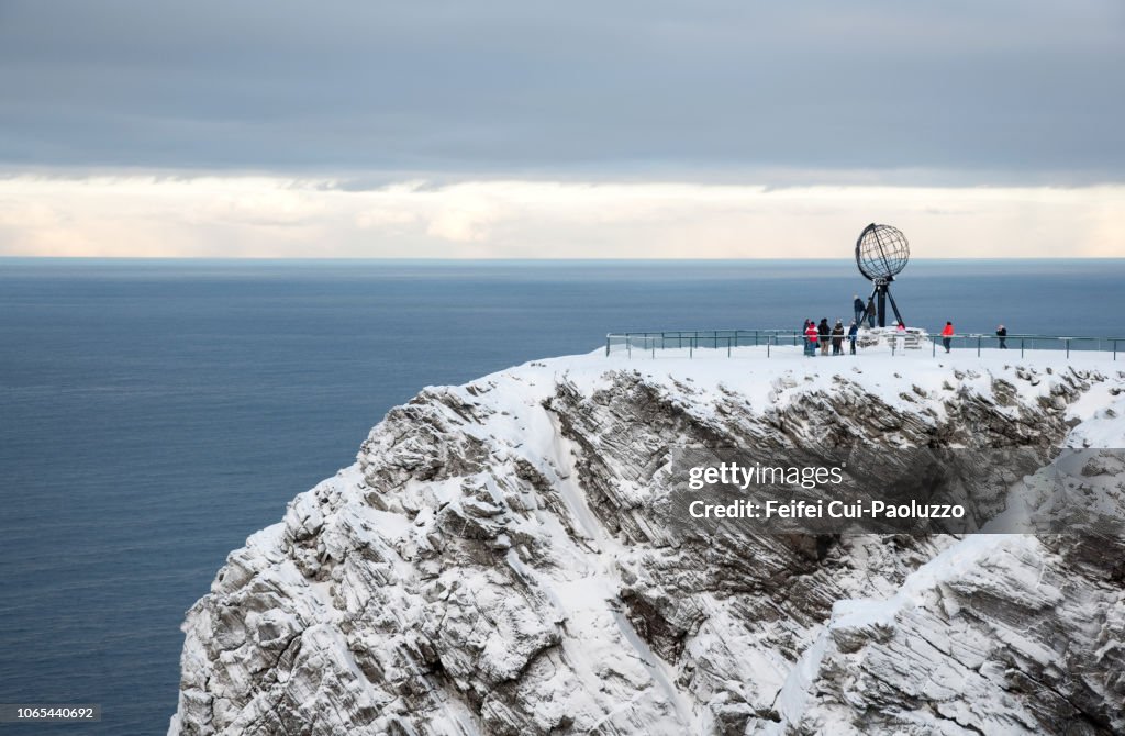 Globe Monument and tourist at North Cape, Northern Norway.