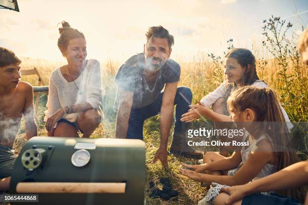 family barbecuing at caravan in rural landscape - family bbq photos et images de collection