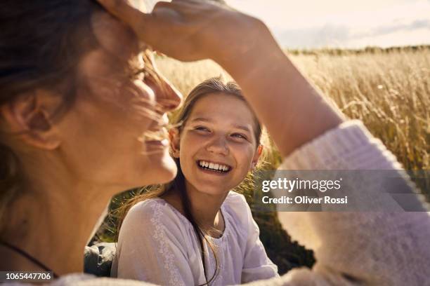 happy mother with daughter at a field - mum daughter foto e immagini stock