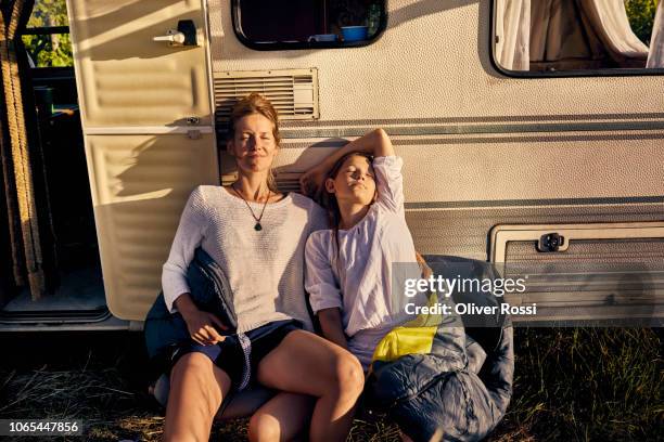 mother with daughter relaxing at a caravan - family caravan stockfoto's en -beelden