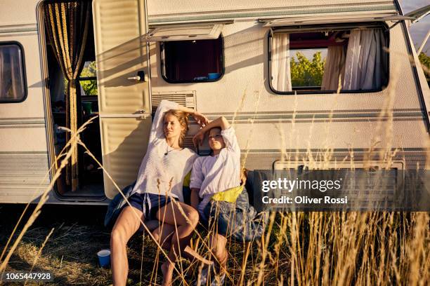 mother with daughter relaxing at a caravan - camper trailer stock pictures, royalty-free photos & images