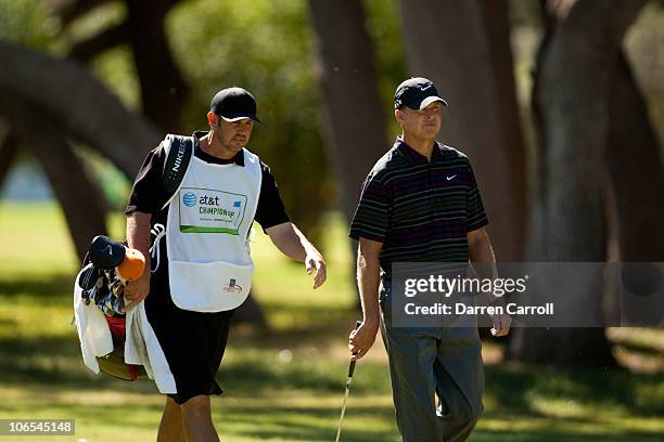 Bob Tway and caddie Scott Tway walk down the second fairway during the first round of the AT&T Championship at Oak Hills Country Club on October 29,...