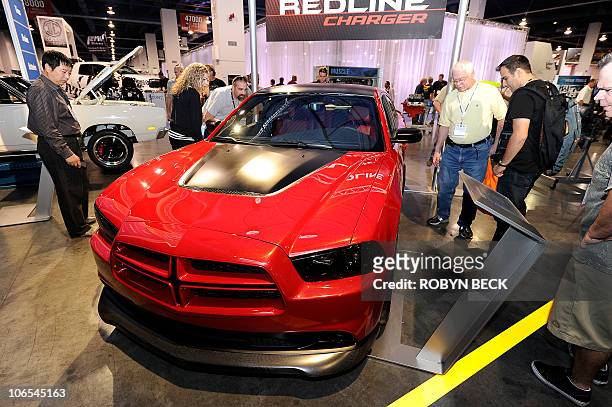 Visitors view the new 2011 Dodge Charger R/T "Redline," at the 2010 Specialty Equipment Market Association trade show in Las Vegas, Nevada November...